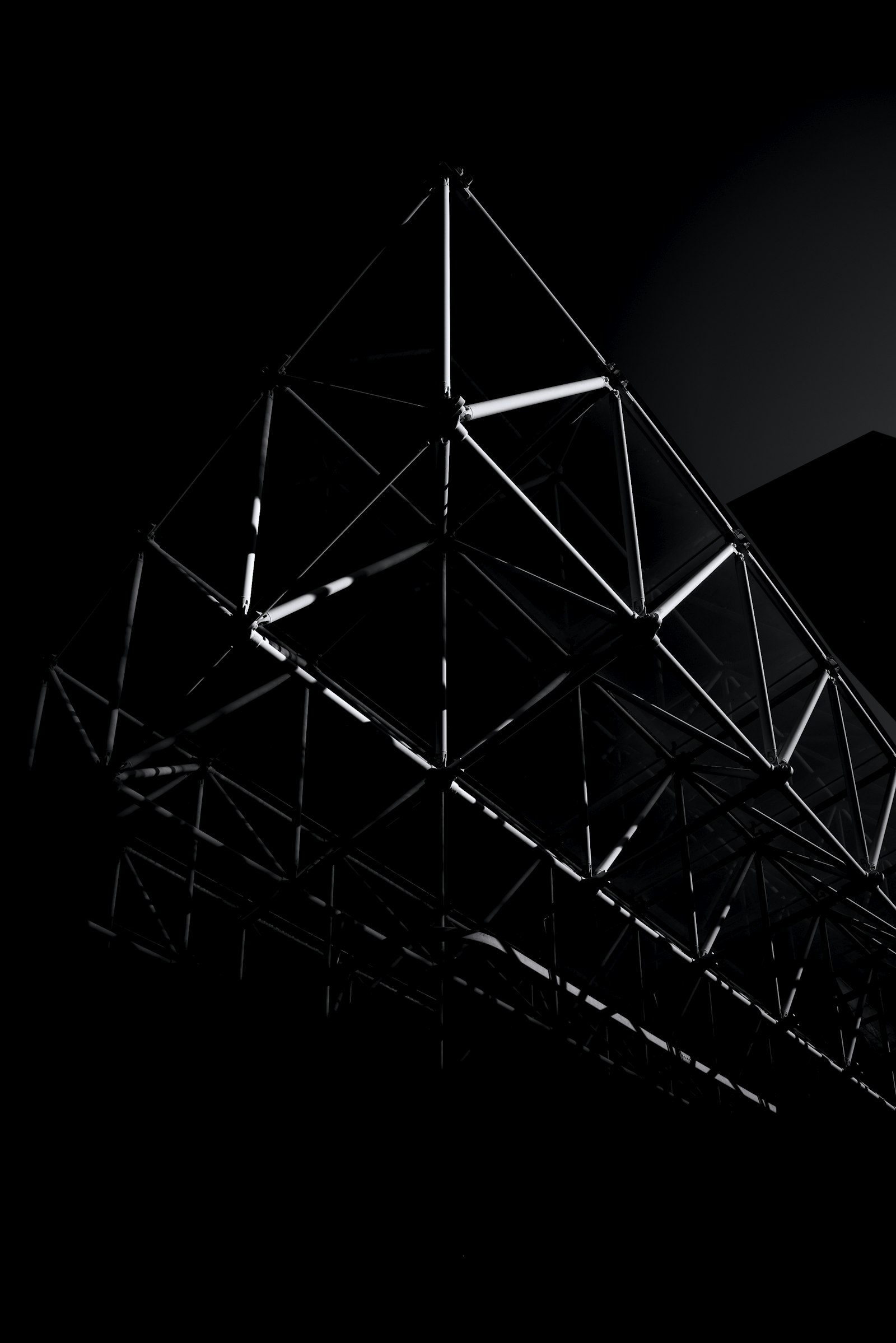 Steel truss against a dark ground